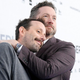 Rooster Teeth co-founders Burnie Burns and Geoff Ramsey embrace at a Warner Bros. event in 2019.